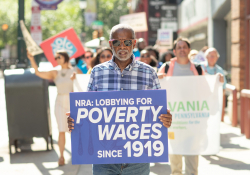July 12, 2019: — Senator Art Haywood and and fellow legislators serve up food, coffee and drinks to customers during the busy happy hour at El Fuego restaurant in support of the federal Raise the Wage Act nationwide and One Fair Wage in the state.